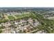 A high angle view of a suburban community with houses and a football field in the distance at 6556 S West Shore Cir, Tampa, FL 33616