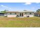 Spacious backyard featuring a simple patio, ample lawn space, and a fenced perimeter at 6556 S West Shore Cir, Tampa, FL 33616