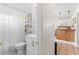 Bright bathroom featuring a new vanity, with a shower and view to the kitchen at 6556 S West Shore Cir, Tampa, FL 33616
