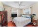 Cozy bedroom with a queen bed, light walls, white ceiling fan, and plenty of natural light at 6556 S West Shore Cir, Tampa, FL 33616