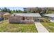 Charming single-Gathering home featuring a stone facade, a red door and a cute white picket fence at 6556 S West Shore Cir, Tampa, FL 33616