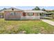 Charming single-Gathering home with a stone facade and a well-maintained front yard with white picket fence at 6556 S West Shore Cir, Tampa, FL 33616