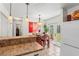 Kitchen with breakfast bar overlooking an eat-in-kitchen area with views to a garden at 6556 S West Shore Cir, Tampa, FL 33616