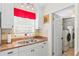 Laundry room with stainless steel sink and ample natural light at 6556 S West Shore Cir, Tampa, FL 33616