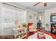 Cozy living room showcasing the glossy red wood floors, bright window and comfortable furnishings at 6556 S West Shore Cir, Tampa, FL 33616