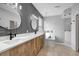 Bathroom featuring a double sink vanity, decorative mirrors, modern chandelier and luxurious soaking tub at 719 Straw Lake Dr, Brandon, FL 33510