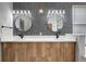 Bathroom featuring double sink with decorative lighting and wall mounted mirrors at 719 Straw Lake Dr, Brandon, FL 33510