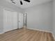 Bright bedroom with wood floors, ceiling fan, and large closet space at 719 Straw Lake Dr, Brandon, FL 33510