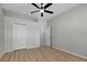 Empty bedroom featuring light walls, ceiling fan and a closet with double doors at 719 Straw Lake Dr, Brandon, FL 33510