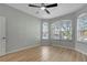 Well-lit bedroom with a ceiling fan, corner windows, and neutral paint at 719 Straw Lake Dr, Brandon, FL 33510