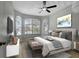 Comfortable bedroom with a large window, ceiling fan and stylish decor at 719 Straw Lake Dr, Brandon, FL 33510
