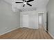Empty bedroom with ceiling fan, double doors, and wood-look flooring at 719 Straw Lake Dr, Brandon, FL 33510