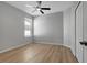 Bedroom featuring a ceiling fan, a window and wood-look flooring at 719 Straw Lake Dr, Brandon, FL 33510