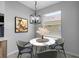Charming dining area with floral arrangements, a round table and a chandelier at 719 Straw Lake Dr, Brandon, FL 33510