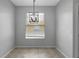 Dining area features neutral paint, decorative light fixture, tile floors, and a bright window for natural light at 719 Straw Lake Dr, Brandon, FL 33510
