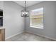 Bright dining area with a modern chandelier and an open view to the kitchen at 719 Straw Lake Dr, Brandon, FL 33510