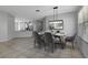 Dining area features a modern light fixture and flows into the kitchen at 719 Straw Lake Dr, Brandon, FL 33510
