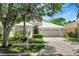 Charming home featuring a manicured front yard, an attached garage, and a welcoming entrance at 719 Straw Lake Dr, Brandon, FL 33510