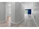 Neutral hallway features tile floors, leading to an open living area with natural light at 719 Straw Lake Dr, Brandon, FL 33510