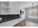 Bright kitchen featuring stainless steel appliances, quartz countertops, modern cabinetry, and adjacent dining area at 719 Straw Lake Dr, Brandon, FL 33510
