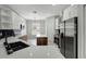 Stylish kitchen with stainless appliances, center island, black hardware, and bright white cabinetry at 719 Straw Lake Dr, Brandon, FL 33510