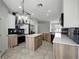Open concept kitchen with a large island, stainless steel appliances, and seamless flow into the dining area at 719 Straw Lake Dr, Brandon, FL 33510