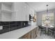 Bright kitchen featuring stainless steel appliances, quartz countertops, modern cabinetry, and adjacent dining area at 719 Straw Lake Dr, Brandon, FL 33510