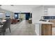 Open concept living room featuring a modern kitchen and blue accent walls at 719 Straw Lake Dr, Brandon, FL 33510