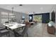 Stylishly furnished living area with blue accent wall, open to the dining area at 719 Straw Lake Dr, Brandon, FL 33510