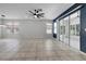 Spacious living room features tile flooring, modern ceiling fan, and sliding glass doors to the lanai at 719 Straw Lake Dr, Brandon, FL 33510