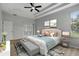Spacious main bedroom showcasing a trey ceiling, ceiling fan, wood floors, and ensuite bath access at 719 Straw Lake Dr, Brandon, FL 33510