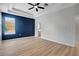 Main bedroom showcasing a trey ceiling, ceiling fan, ensuite bath access, and wood floors at 719 Straw Lake Dr, Brandon, FL 33510