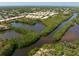 Aerial view of waterfront condos with beautiful mangrove islands and waterways throughout community at 7657 Caponata Blvd, Seminole, FL 33777