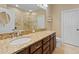 Elegant bathroom featuring double sinks with granite counters and dark wood cabinetry at 7657 Caponata Blvd, Seminole, FL 33777