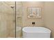 Bright bathroom showcasing a modern tub and separate glass-enclosed shower at 7657 Caponata Blvd, Seminole, FL 33777