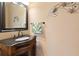 Charming bathroom featuring a stylish vanity, elegant mirror, and coastal-themed decor at 7657 Caponata Blvd, Seminole, FL 33777