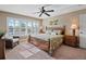Tranquil bedroom featuring plantation shutters and a ceiling fan, offering a relaxing retreat at 7657 Caponata Blvd, Seminole, FL 33777