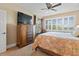 Bedroom featuring a large window, a TV, and a dresser with wooden drawers at 7657 Caponata Blvd, Seminole, FL 33777
