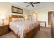 Bedroom with a decorative painting and a bed with nightstands and lamps at 7657 Caponata Blvd, Seminole, FL 33777
