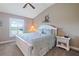 Serene bedroom with a large window, plantation shutters, and a comfortable bed for restful nights at 7657 Caponata Blvd, Seminole, FL 33777