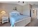 Charming bedroom featuring a queen bed with beach-themed decor and a nightstand with lamp at 7657 Caponata Blvd, Seminole, FL 33777