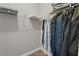 Walk-in closet with organized hanging storage, maximizing space and functionality at 7657 Caponata Blvd, Seminole, FL 33777
