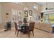 Bright dining area features a round glass table, stylish chandelier, and large windows for plenty of natural light at 7657 Caponata Blvd, Seminole, FL 33777