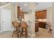 Kitchen features counter seating, granite countertops, and wooden cabinetry at 7657 Caponata Blvd, Seminole, FL 33777