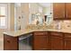 This kitchen offers a stainless steel dishwasher, granite countertops and an open view to the living area at 7657 Caponata Blvd, Seminole, FL 33777