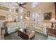 Spacious living room featuring soaring ceilings, clerestory windows, a comfortable sofa, and a large ceiling fan at 7657 Caponata Blvd, Seminole, FL 33777