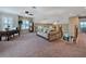 Open loft area with plush carpet, comfortable seating, and a built-in desk, perfect for relaxing or working from home at 7657 Caponata Blvd, Seminole, FL 33777