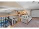Spacious loft overlooking the living area, complete with comfortable sofa and views of the lower level at 7657 Caponata Blvd, Seminole, FL 33777