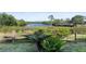 Picturesque view of a tranquil pond surrounded by lush greenery and mature trees at 7657 Caponata Blvd, Seminole, FL 33777