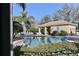 Community pool surrounded by lush landscaping offering a relaxing oasis at 7657 Caponata Blvd, Seminole, FL 33777